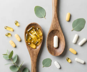 Flat lay of healthy wellness supplements and natural ingredients on a clean white background